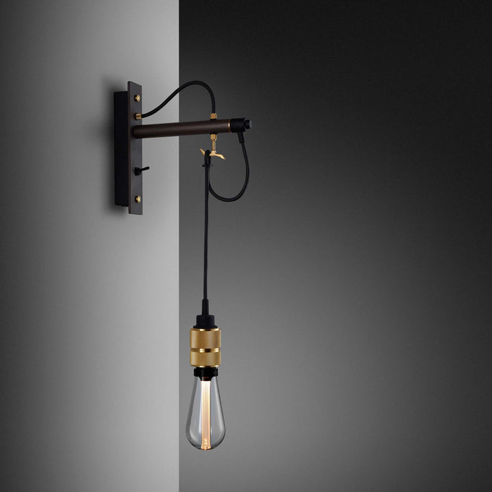 Hooked Nude Wall Light in Graphite/Brass.