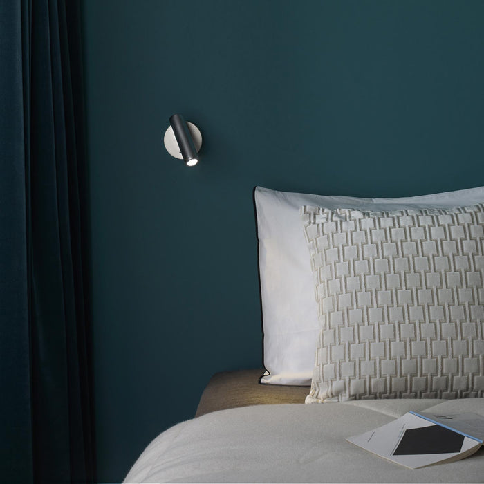 Enna Round LED Wall Light in bedroom.