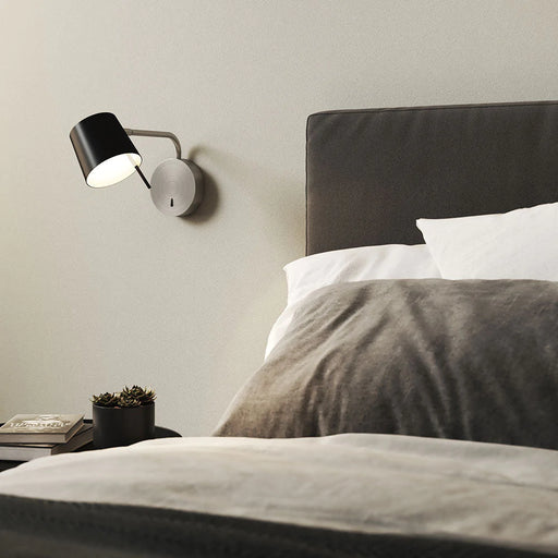 Miura LED Swing Arm Wall Light in bedroom.
